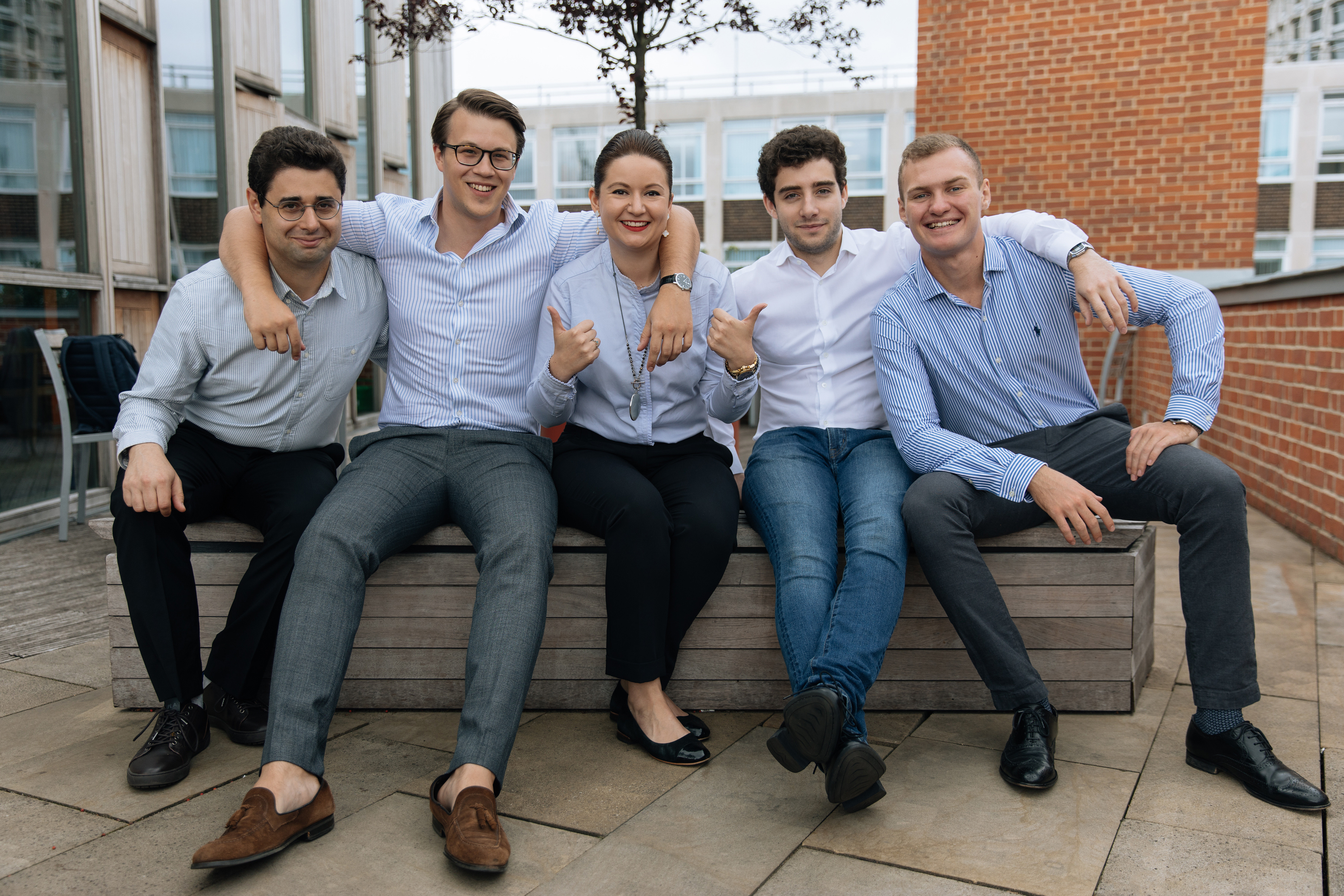 The founders of PitchMe sitting on a bench